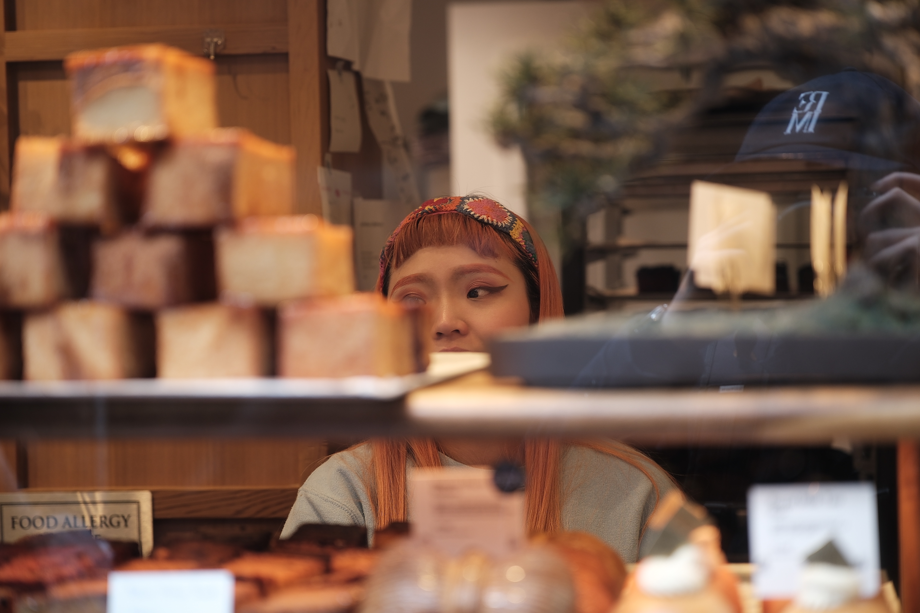 Woman seen through a bakery window