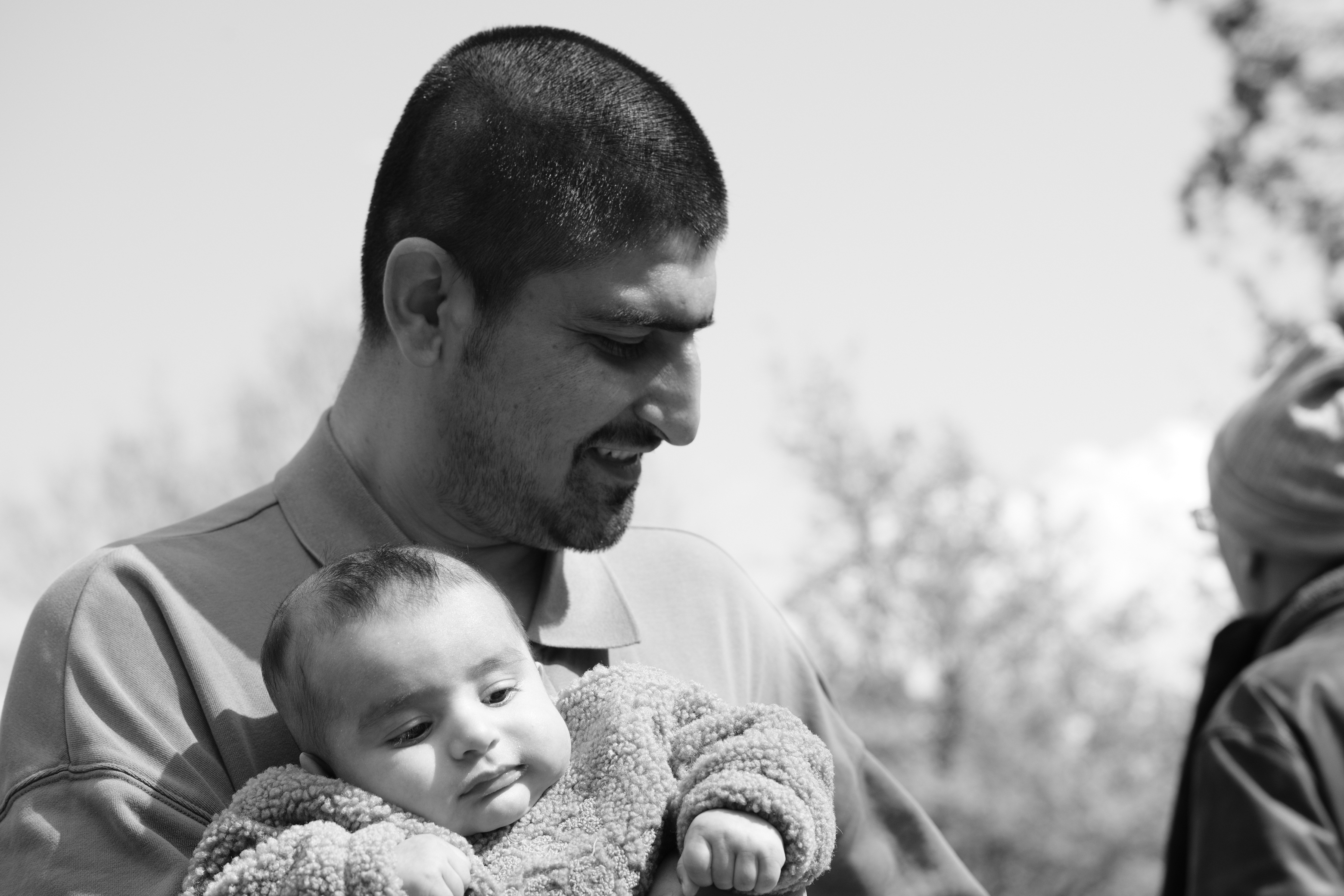 Father holding baby in black and white