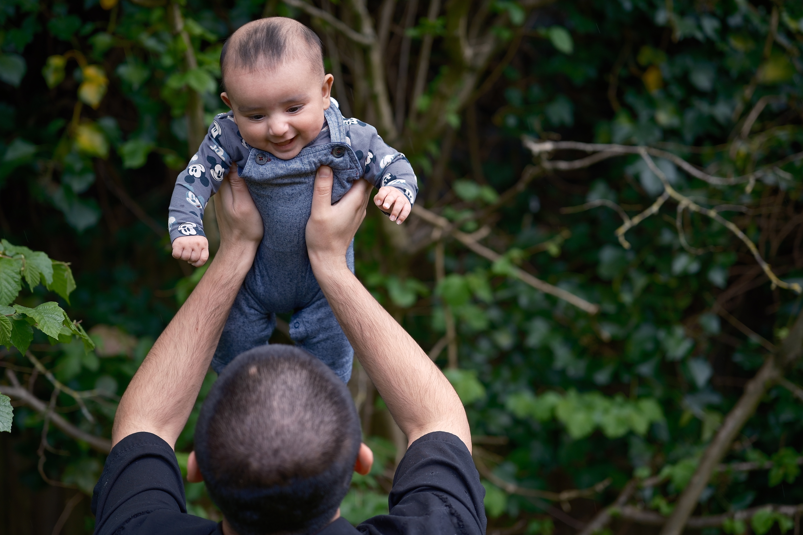 Baby held up in the air by father